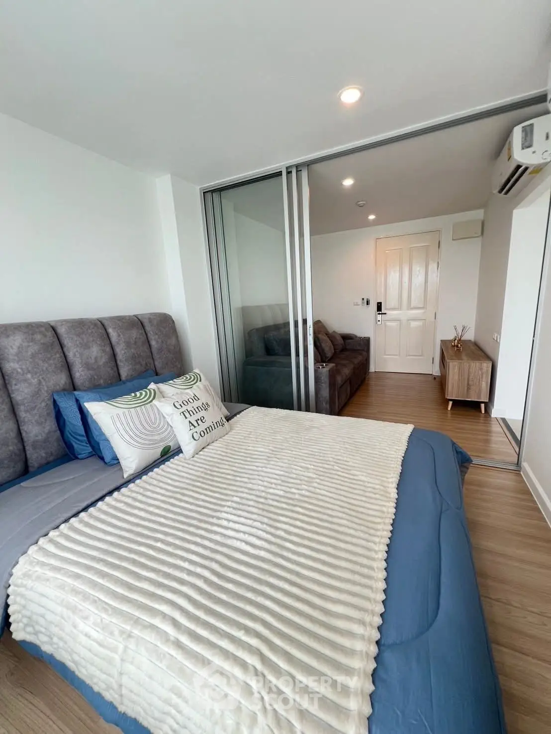 Modern bedroom with sliding glass doors and cozy decor