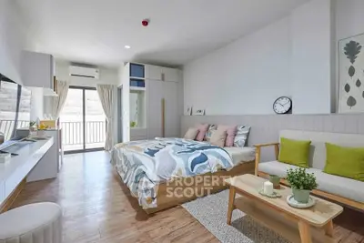 Modern bedroom with stylish decor and balcony access in a bright apartment.