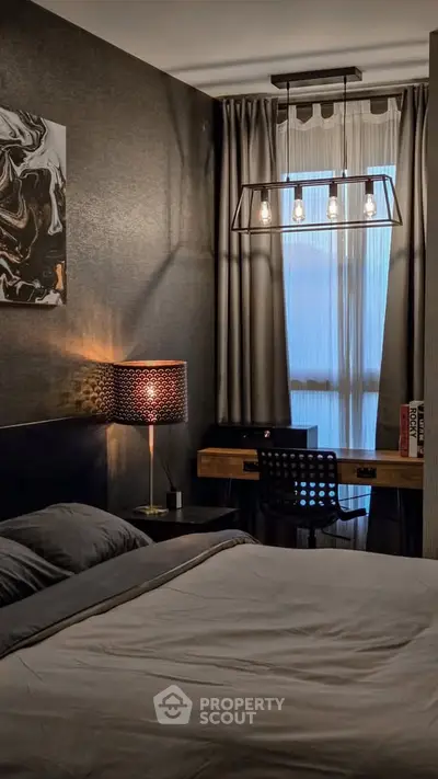 Cozy bedroom with modern decor and ambient lighting, featuring a stylish desk and chair by the window.