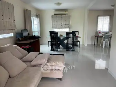 Spacious living and dining area with modern furniture and natural light.