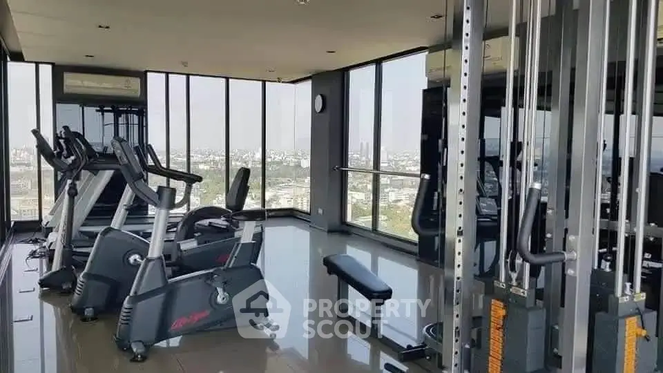 Modern gym with panoramic city views and state-of-the-art fitness equipment.