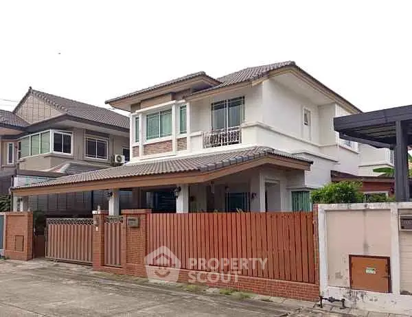 Charming two-story suburban house with a fenced yard and modern design.