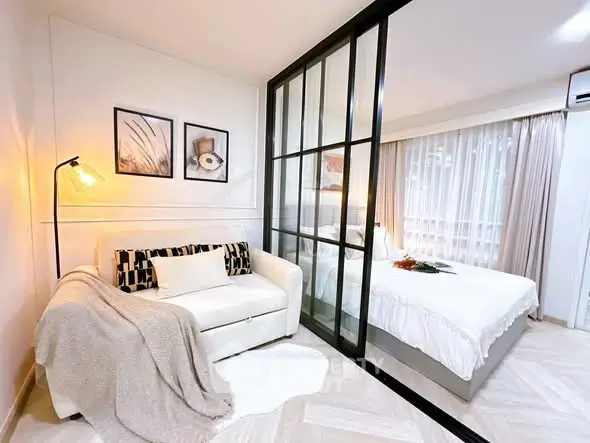 Modern studio apartment with glass partition and cozy decor