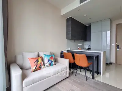 Modern open-layout living room with stylish kitchen and vibrant decor