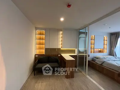 Modern studio apartment with sleek design, featuring a cozy living area and stylish bedroom with ambient lighting.