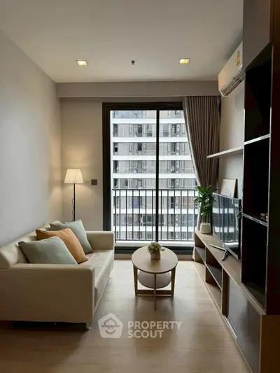 Modern living room with cozy sofa and city view balcony