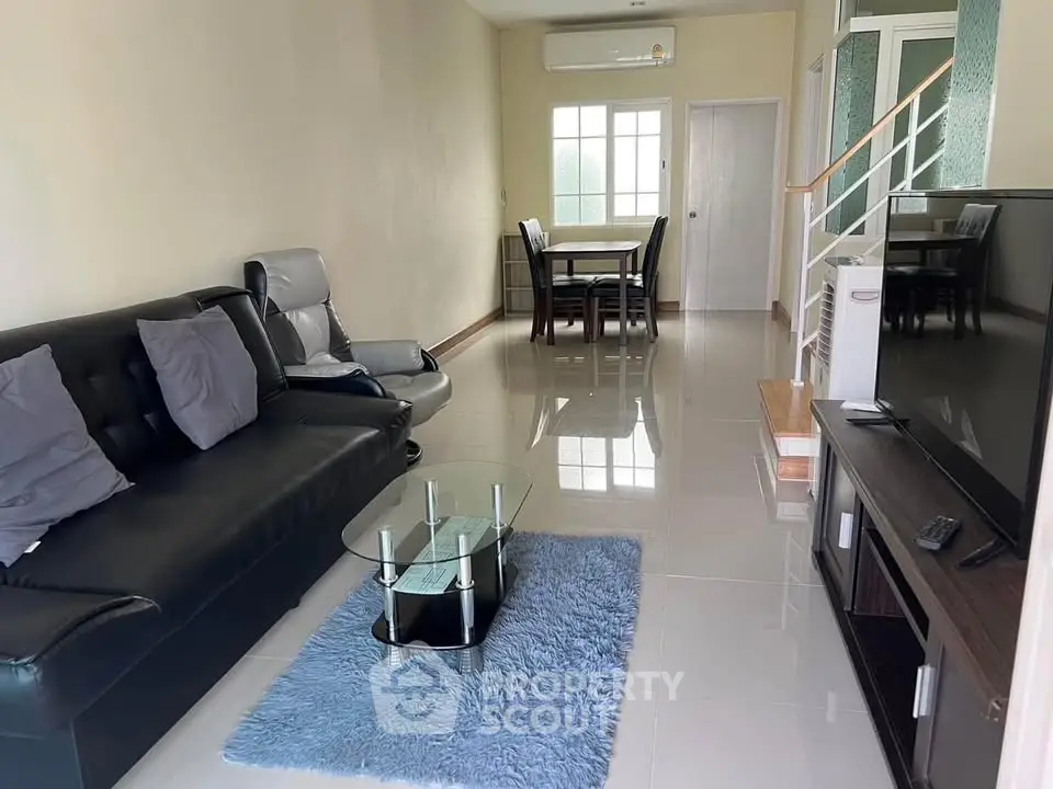 Spacious living room with modern furniture and sleek design, perfect for relaxation and entertainment.
