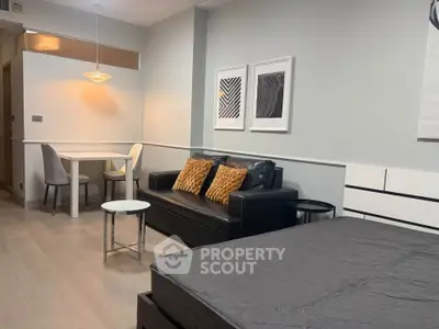 Modern studio apartment with stylish decor and cozy seating area, perfect for urban living.
