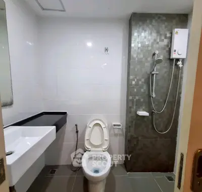 Modern bathroom with sleek fixtures and tiled shower area