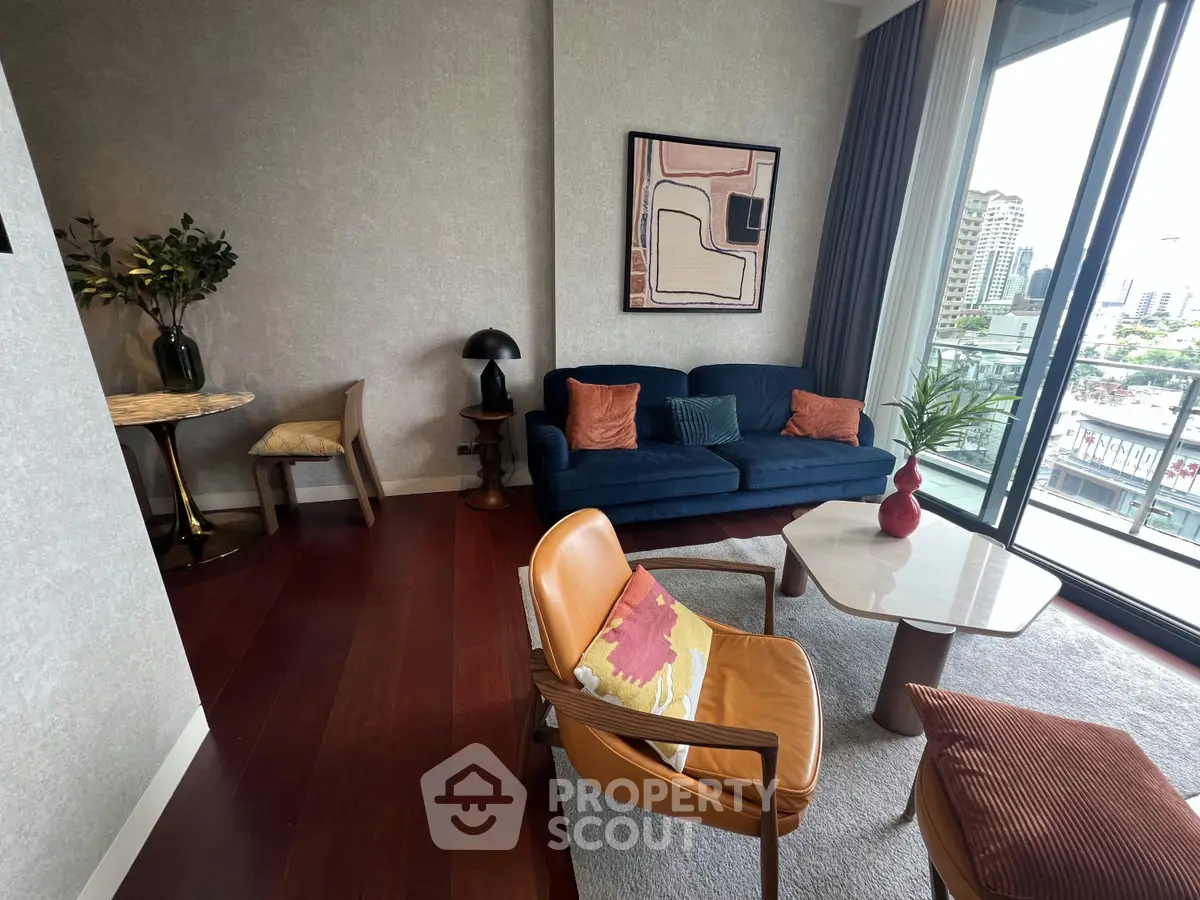 Stylish living room with modern furniture and city view balcony, perfect for urban living.