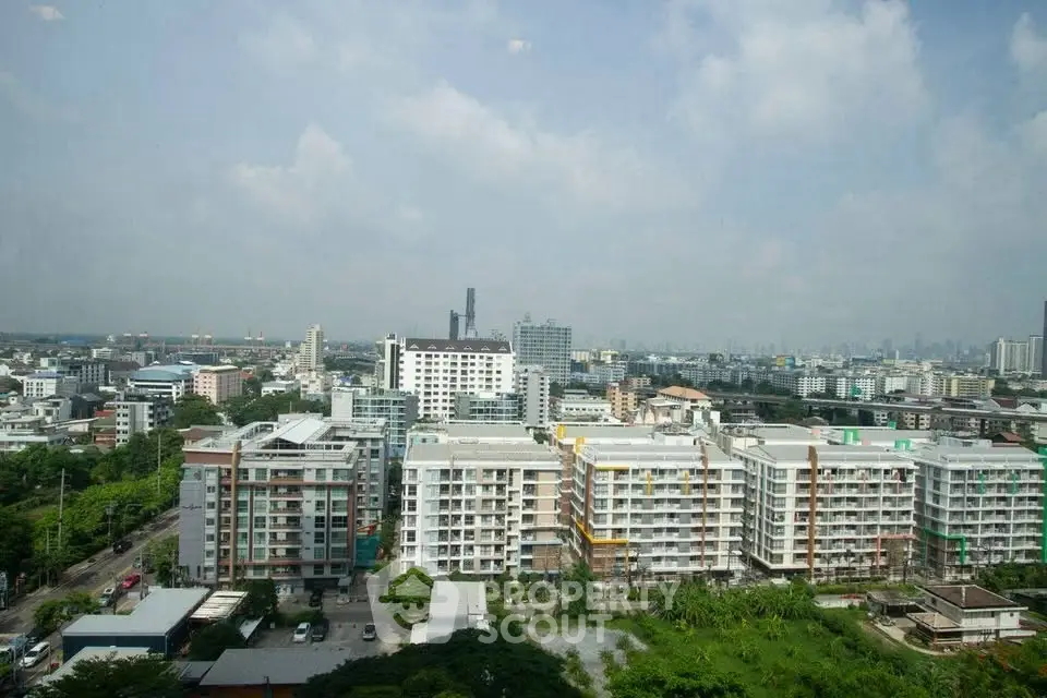 Panoramic cityscape view showcasing modern residential buildings and lush greenery.