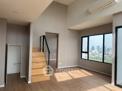 Spacious modern loft with wooden staircase and panoramic city view