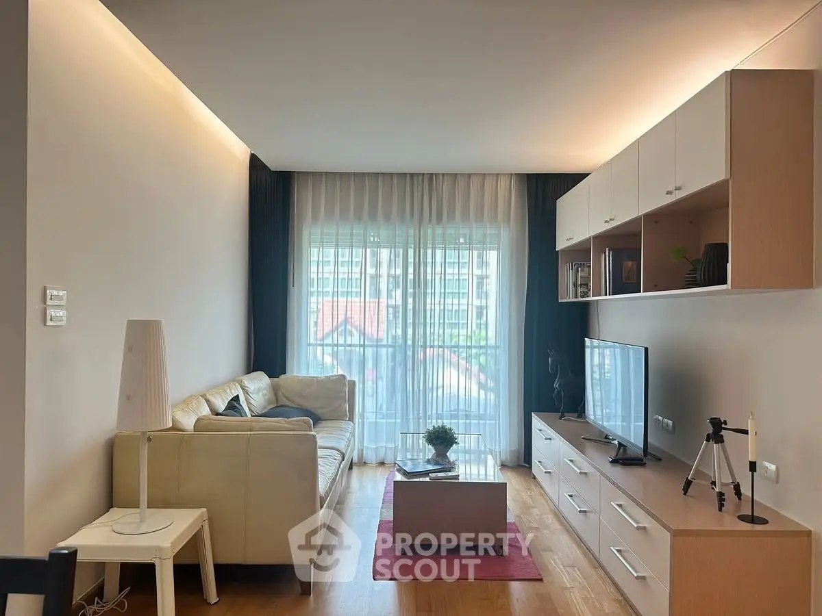 Modern living room with sleek furniture and large window view
