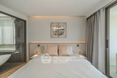 Luxurious bedroom with modern decor and ensuite bathroom featuring a stylish bathtub.