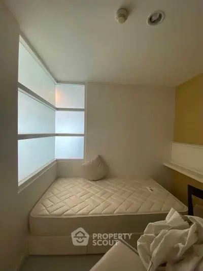 Cozy minimalist bedroom with natural light and modern design