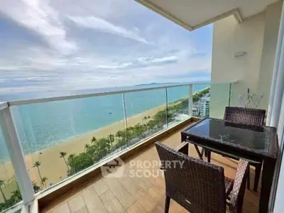 Stunning beachfront balcony with panoramic ocean views and stylish outdoor seating.