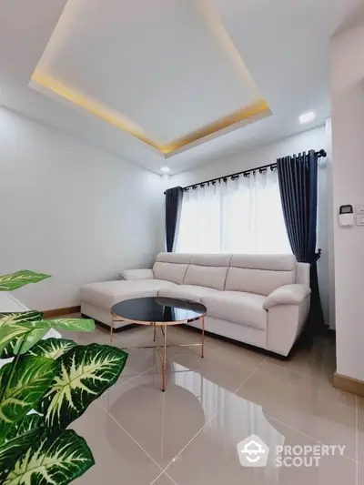 Modern living room with stylish white sofa and elegant ceiling lighting