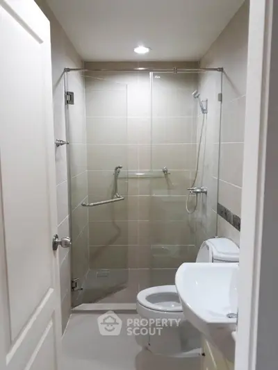 Modern bathroom with glass shower enclosure and sleek fixtures