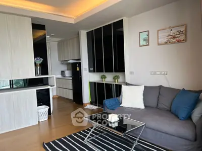 Modern living room with stylish decor and open kitchen layout in a contemporary apartment.