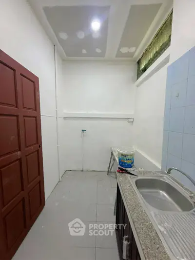 Spacious kitchen with modern sink and ample storage space