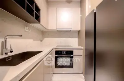 Modern kitchen with sleek cabinetry and built-in oven