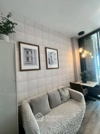 Chic living room with cozy sofa and elegant wall decor, perfect for modern urban living.