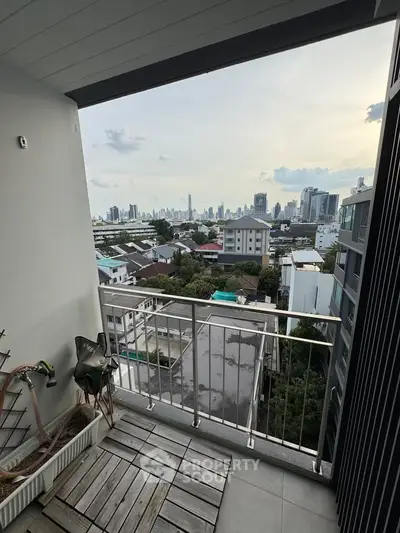 Stunning cityscape view from a modern balcony with sleek railing and urban skyline.