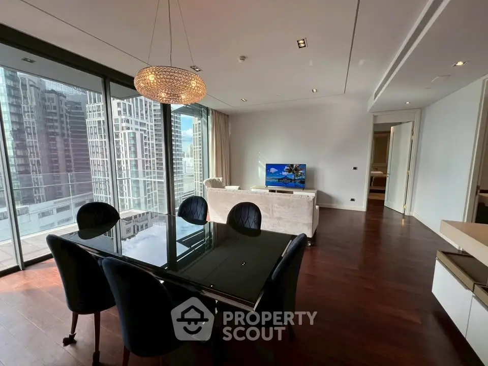 Luxurious modern living room with city view, elegant dining area, and sleek furnishings in high-rise apartment.