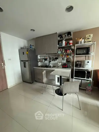 Modern kitchen with sleek cabinetry, stainless steel appliances, and minimalist design in a cozy apartment.
