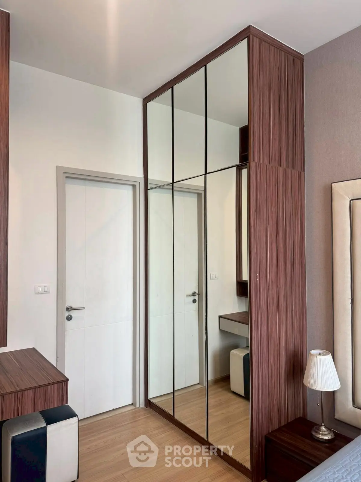 Modern bedroom with mirrored wardrobe and stylish decor