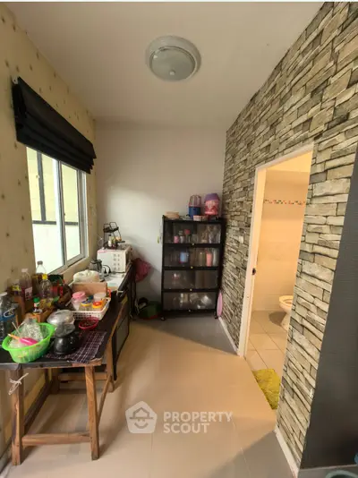 Cozy kitchen with stone accent wall and ample natural light