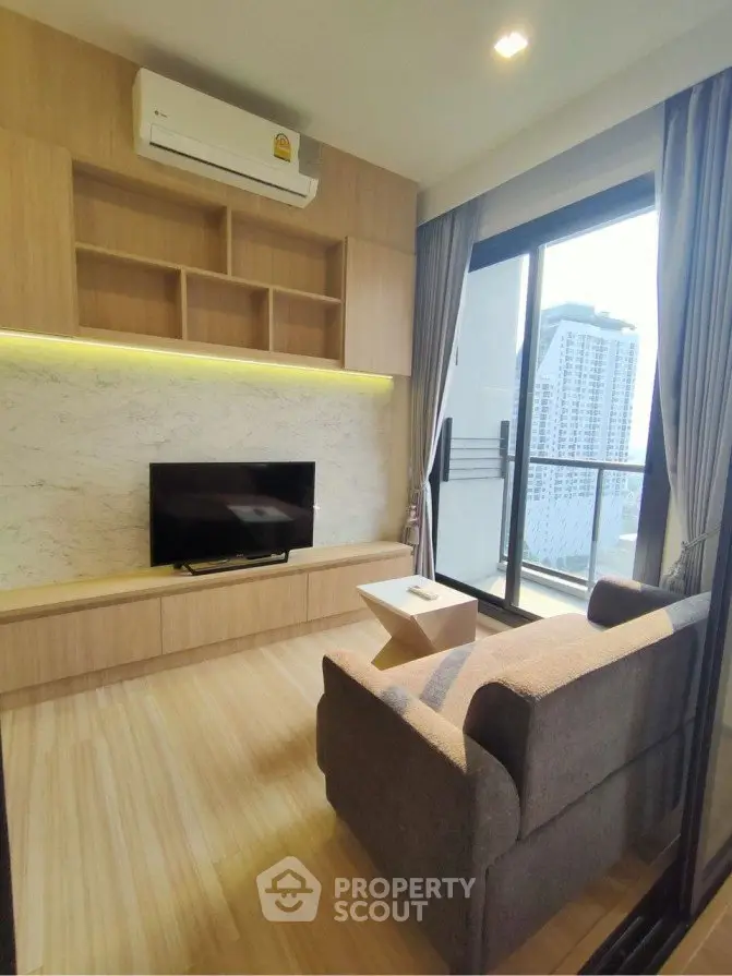 Modern living room with city view, featuring sleek furniture and stylish decor.