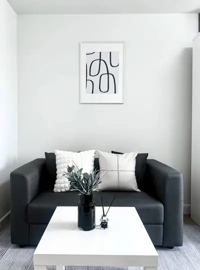 Modern living room with stylish sofa and abstract art, perfect for contemporary urban living.
