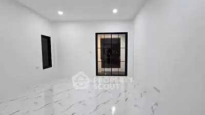 Spacious modern living room with sleek marble flooring and large windows for natural light.