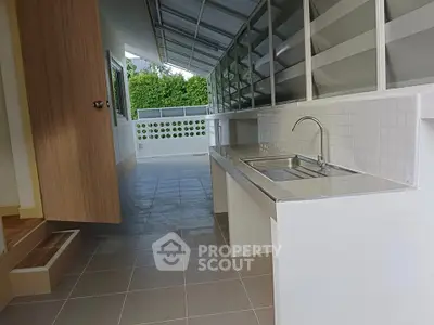 Spacious outdoor kitchen with modern sink and ample counter space, perfect for entertaining.