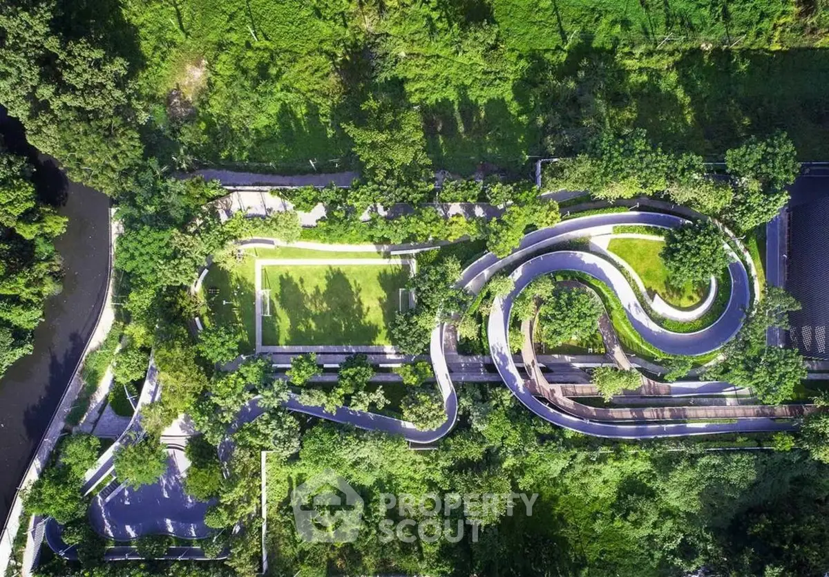 Stunning aerial view of lush green garden with winding pathways and vibrant landscaping.