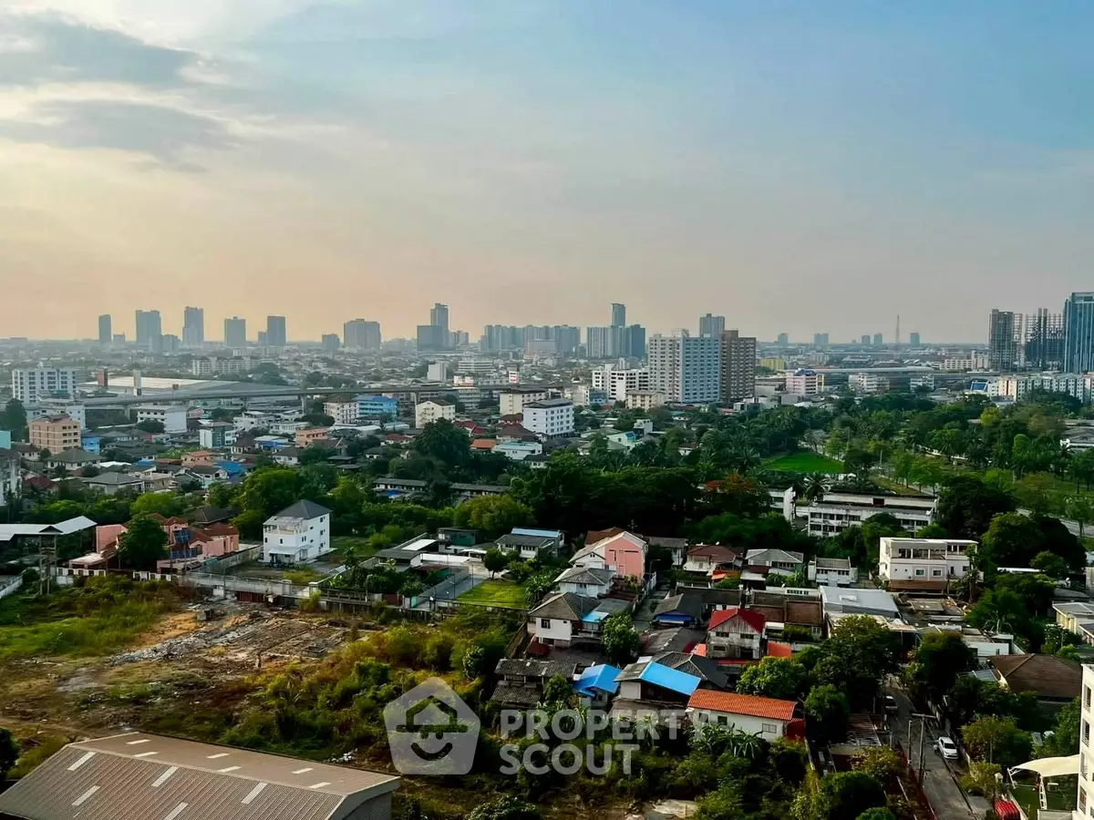 Stunning cityscape view showcasing urban skyline and residential areas at sunset.