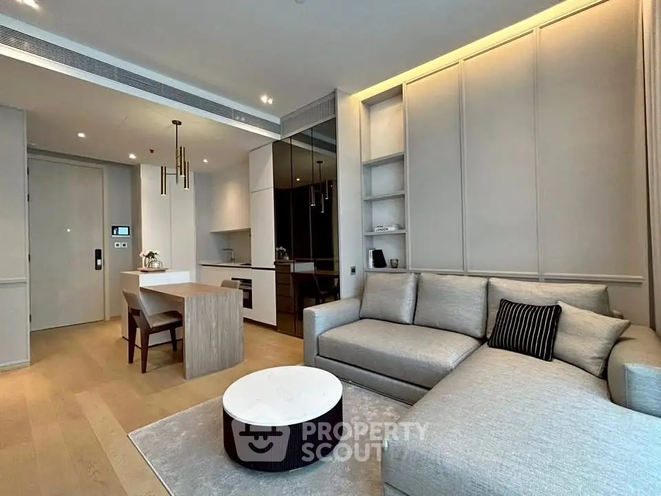 Modern living room with sleek furniture and open kitchen layout in luxury apartment.