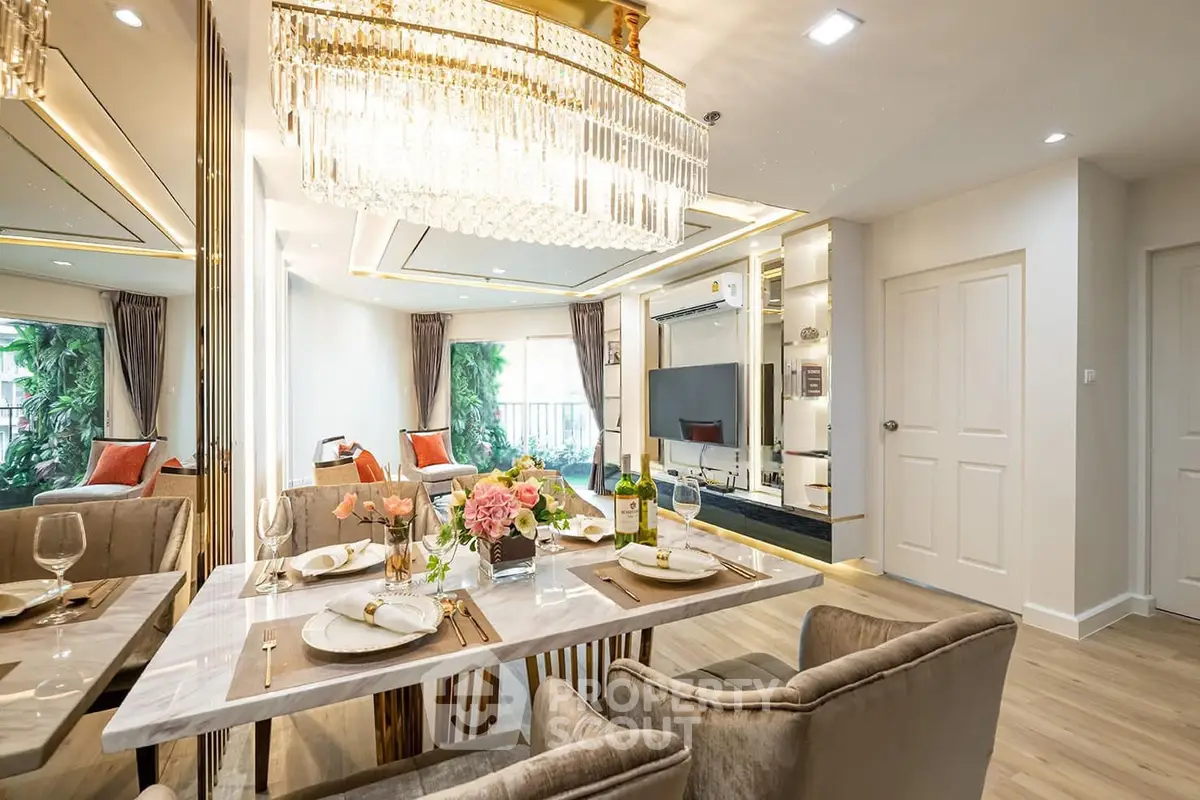 Luxurious open-plan living and dining area with elegant chandelier and modern decor