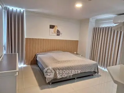 Spacious bedroom with modern decor and ample natural light