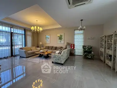 Spacious and elegant living room with modern decor and ample natural light.