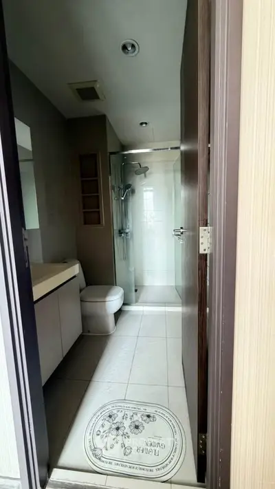 Modern bathroom with glass shower and sleek fixtures in a contemporary apartment.