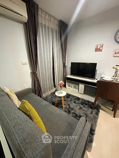 Cozy living room with modern decor and plush rug, perfect for relaxation.