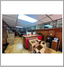 Spacious storage room with boxes and office equipment, ideal for organization and utility.