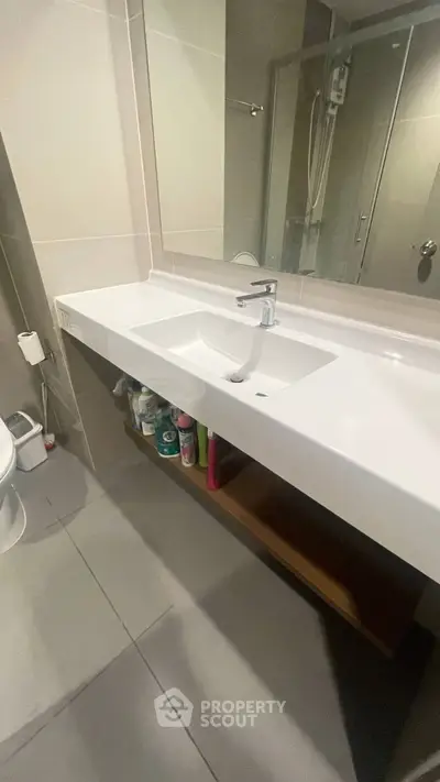 Modern bathroom with sleek sink and shower, ideal for contemporary living.