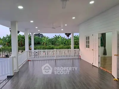 Spacious covered balcony with garden view and modern lighting