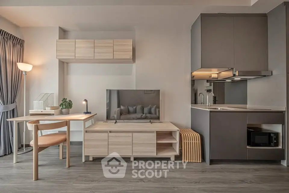 Modern living room with sleek furniture and open kitchen layout, perfect for urban living.