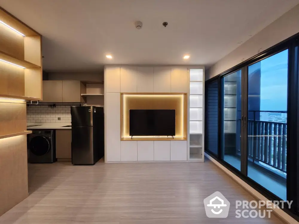 Modern living room with sleek built-in entertainment unit and balcony view