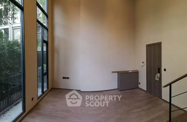 Spacious modern living room with high ceilings and large windows