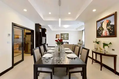 Elegant dining room with modern decor and open layout, featuring a stylish dining table set and contemporary artwork.